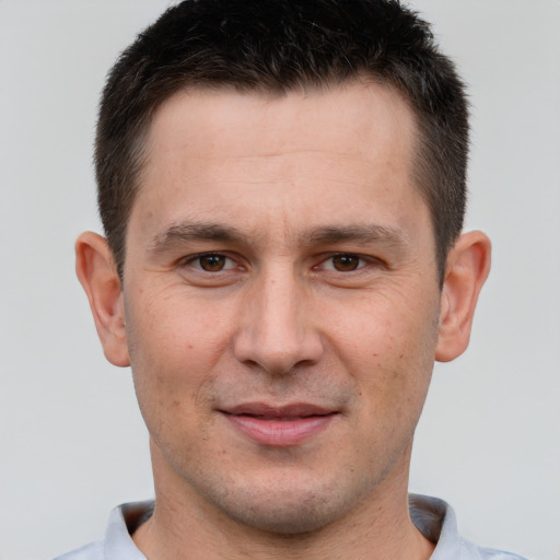 Joyful white adult male with short  brown hair and brown eyes