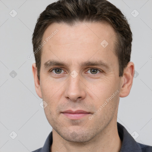 Joyful white young-adult male with short  brown hair and grey eyes