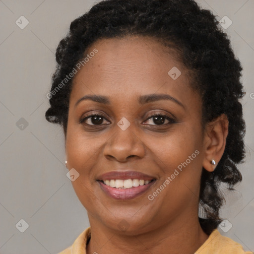 Joyful black young-adult female with long  brown hair and brown eyes