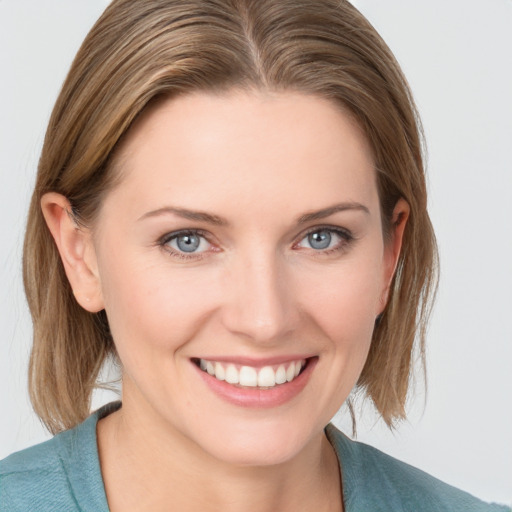 Joyful white young-adult female with medium  brown hair and blue eyes