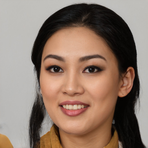 Joyful asian young-adult female with long  black hair and brown eyes