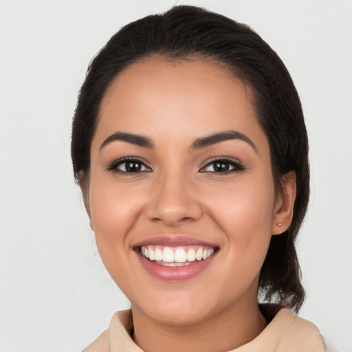 Joyful latino young-adult female with medium  black hair and brown eyes