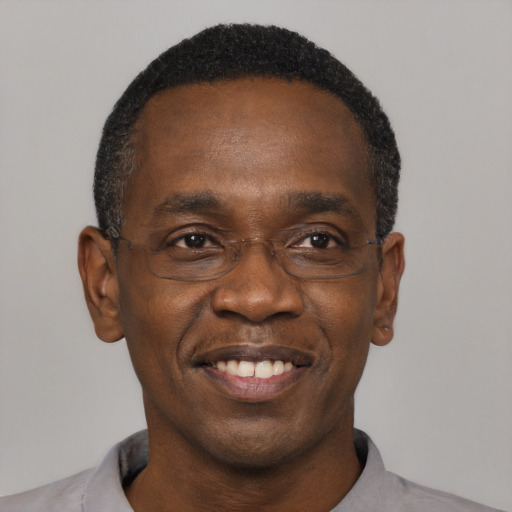 Joyful black adult male with short  black hair and brown eyes