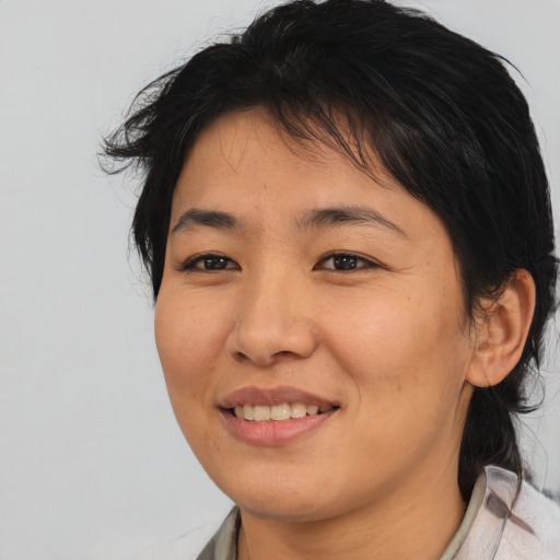 Joyful asian young-adult female with medium  brown hair and brown eyes