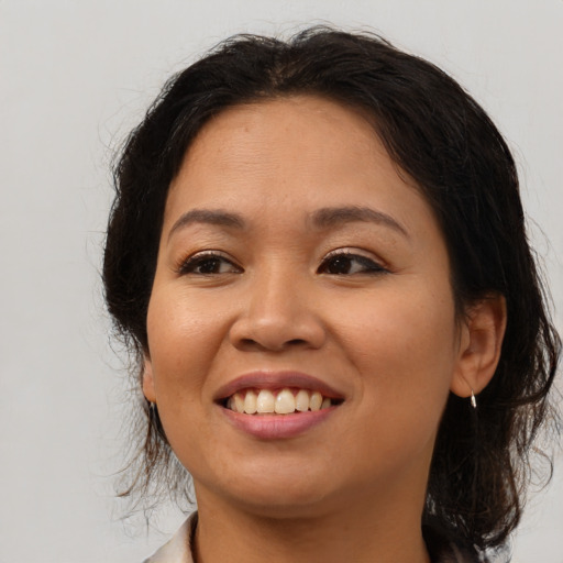 Joyful asian young-adult female with medium  brown hair and brown eyes