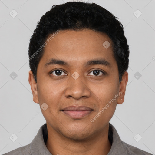 Joyful latino young-adult male with short  black hair and brown eyes