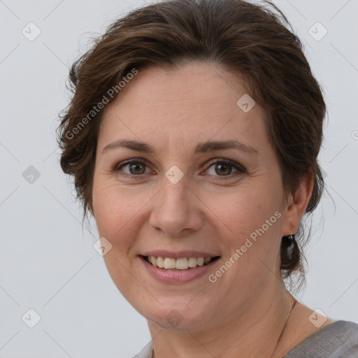 Joyful white adult female with short  brown hair and brown eyes