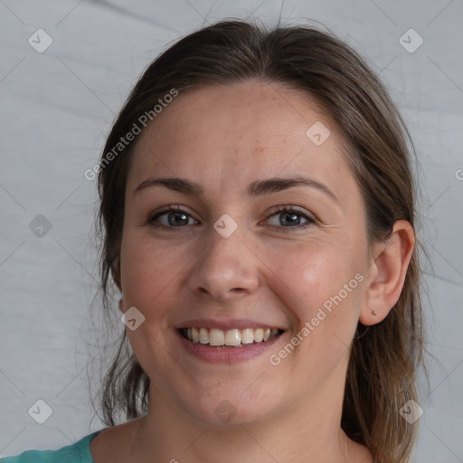 Joyful white adult female with medium  brown hair and grey eyes