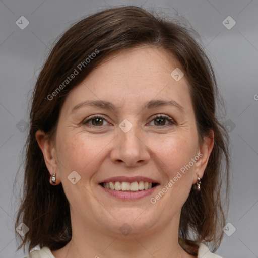 Joyful white adult female with medium  brown hair and grey eyes