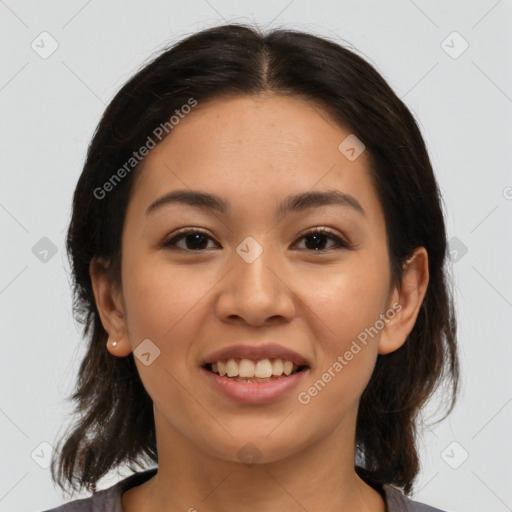 Joyful latino young-adult female with medium  brown hair and brown eyes