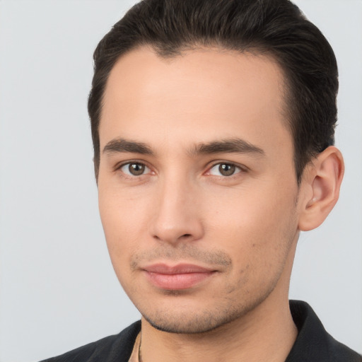 Joyful white young-adult male with short  brown hair and brown eyes