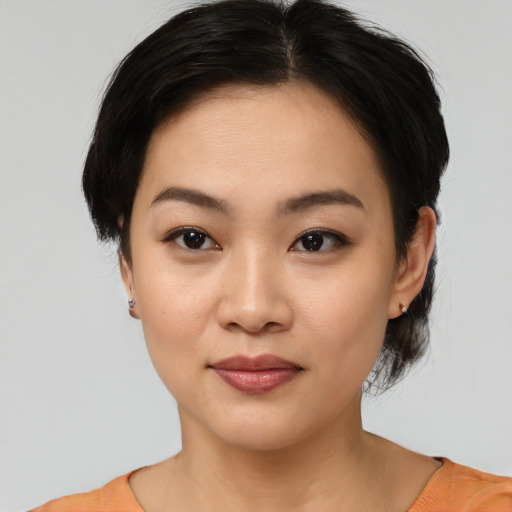 Joyful asian young-adult female with medium  brown hair and brown eyes