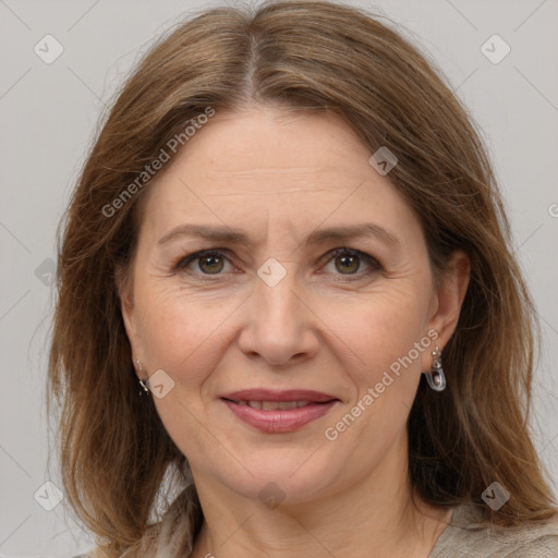 Joyful white adult female with medium  brown hair and grey eyes