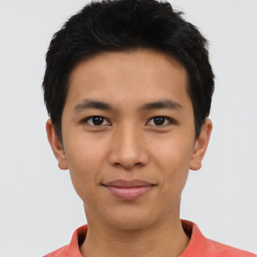 Joyful asian young-adult male with short  brown hair and brown eyes