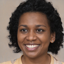 Joyful black young-adult female with medium  brown hair and brown eyes