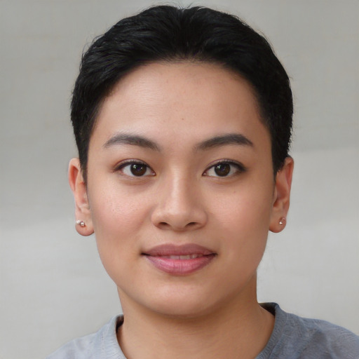 Joyful asian young-adult female with short  black hair and brown eyes