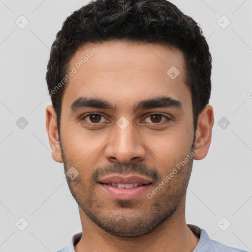 Joyful latino young-adult male with short  black hair and brown eyes