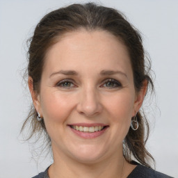 Joyful white adult female with medium  brown hair and grey eyes