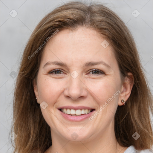 Joyful white adult female with medium  brown hair and grey eyes