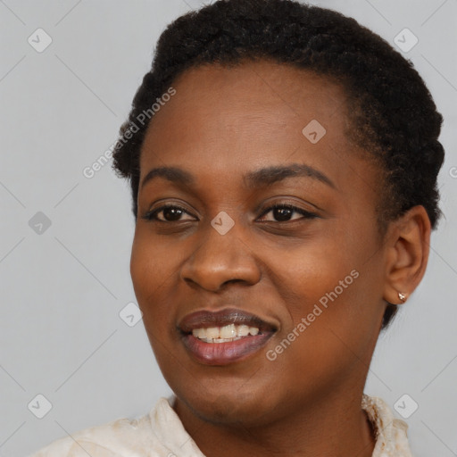 Joyful black young-adult female with short  black hair and brown eyes