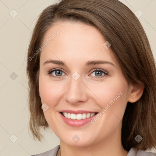 Joyful white young-adult female with medium  brown hair and green eyes