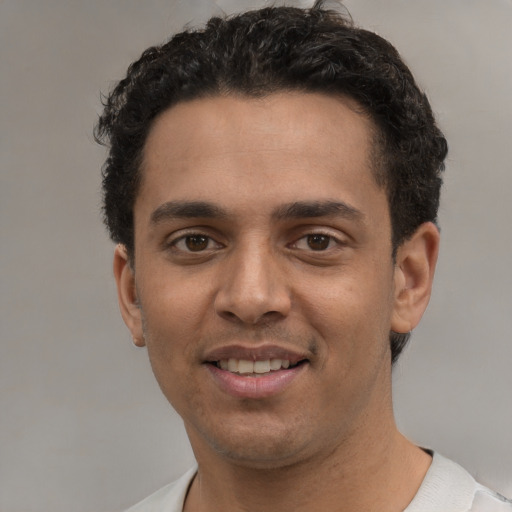 Joyful white young-adult male with short  black hair and brown eyes