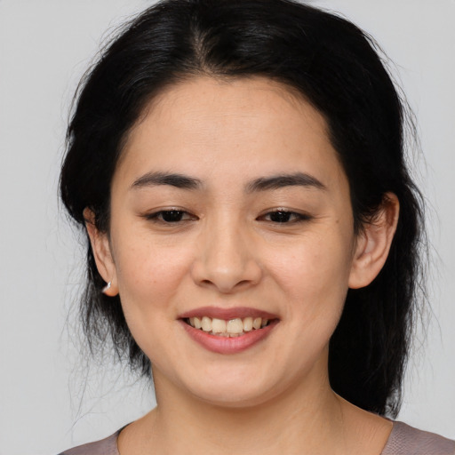 Joyful asian young-adult female with medium  black hair and brown eyes