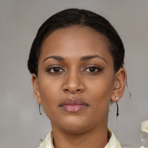 Neutral black young-adult female with medium  brown hair and brown eyes