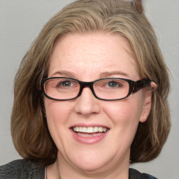 Joyful white adult female with medium  brown hair and blue eyes