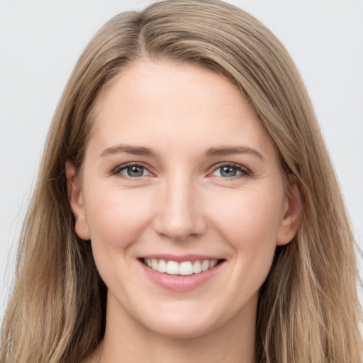 Joyful white young-adult female with long  brown hair and grey eyes