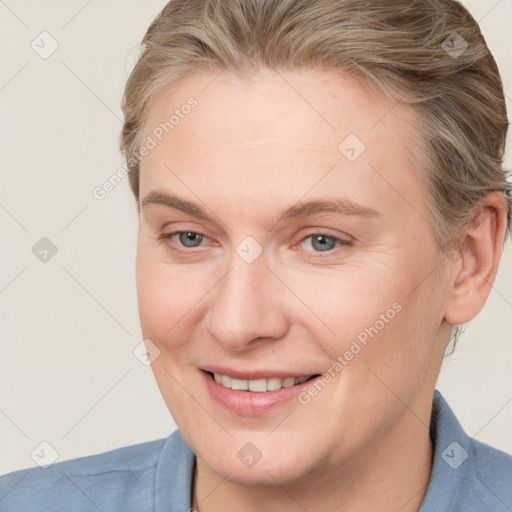 Joyful white adult female with medium  brown hair and blue eyes