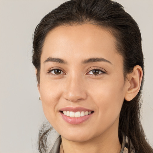 Joyful white young-adult female with long  brown hair and brown eyes