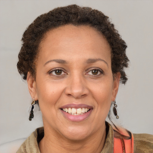 Joyful latino adult female with short  brown hair and brown eyes