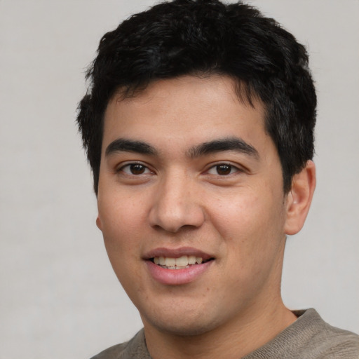 Joyful asian young-adult male with short  black hair and brown eyes