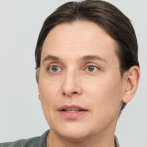 Joyful white adult male with short  brown hair and grey eyes