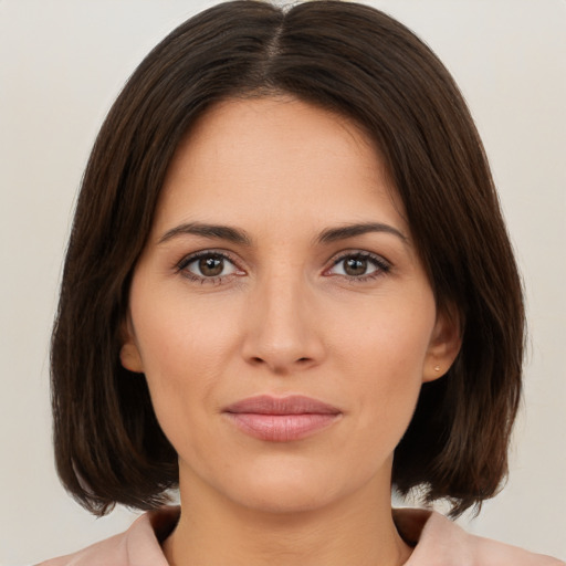 Joyful white young-adult female with medium  brown hair and brown eyes