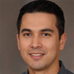 Joyful white young-adult male with short  black hair and brown eyes