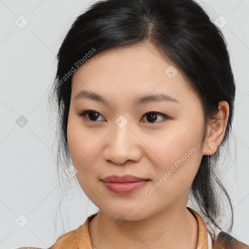 Joyful asian young-adult female with medium  black hair and brown eyes