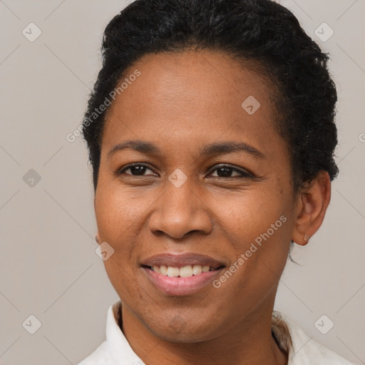 Joyful black adult female with short  brown hair and brown eyes