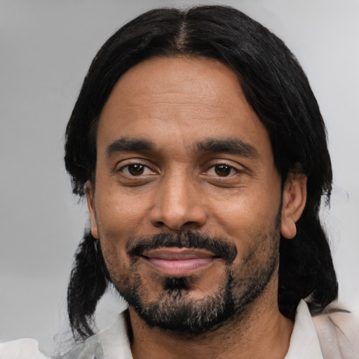Joyful black adult male with medium  black hair and brown eyes