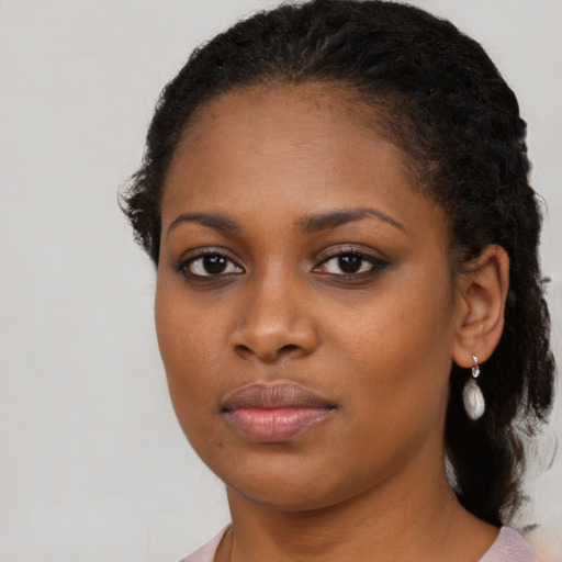 Joyful black young-adult female with medium  black hair and brown eyes