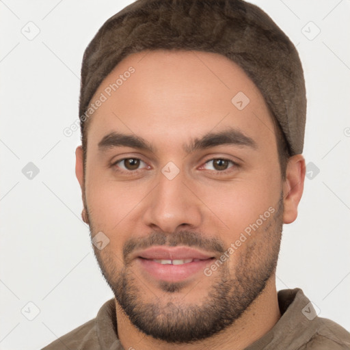 Joyful white young-adult male with short  black hair and brown eyes