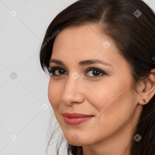 Joyful white young-adult female with long  brown hair and brown eyes