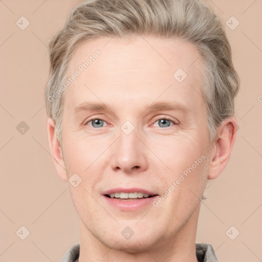 Joyful white adult male with short  brown hair and grey eyes