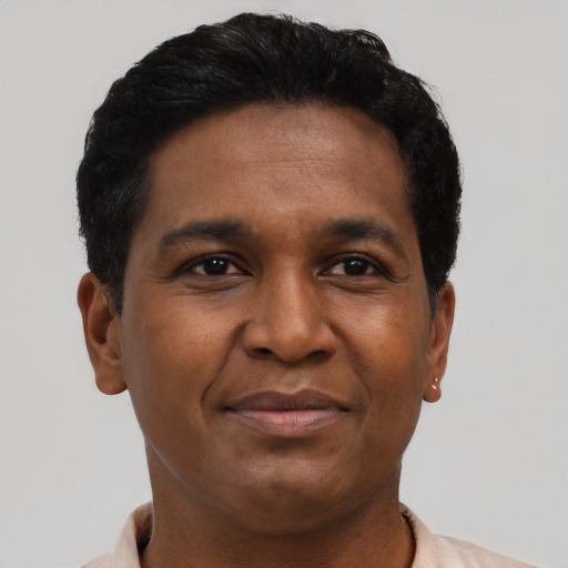 Joyful black young-adult male with short  brown hair and brown eyes