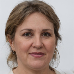 Joyful white adult female with medium  brown hair and grey eyes