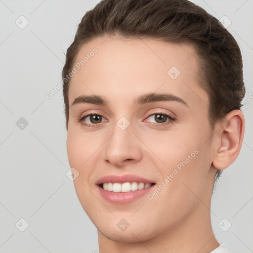 Joyful white young-adult female with short  brown hair and brown eyes