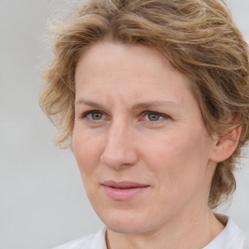 Joyful white adult female with medium  brown hair and blue eyes