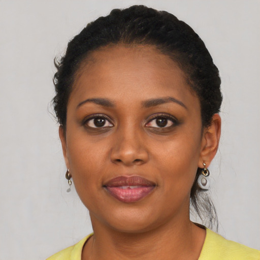 Joyful black young-adult female with short  brown hair and brown eyes
