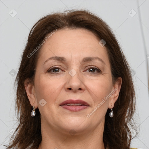 Joyful white adult female with long  brown hair and grey eyes